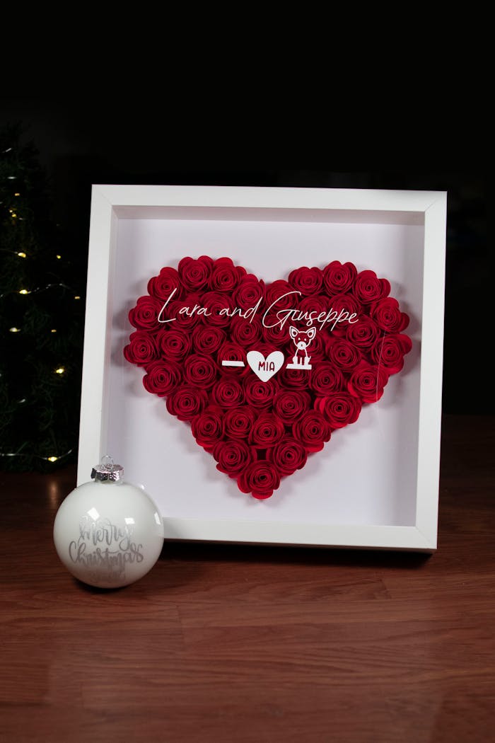 Elegant heart-shaped red rose display in a frame with personal text, ideal for romantic settings.